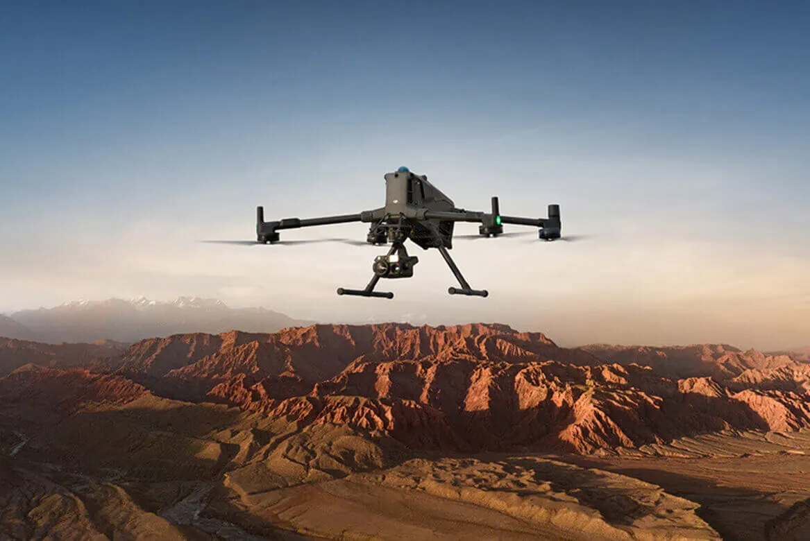 Tactical drone operation at sunset over mountainous terrain